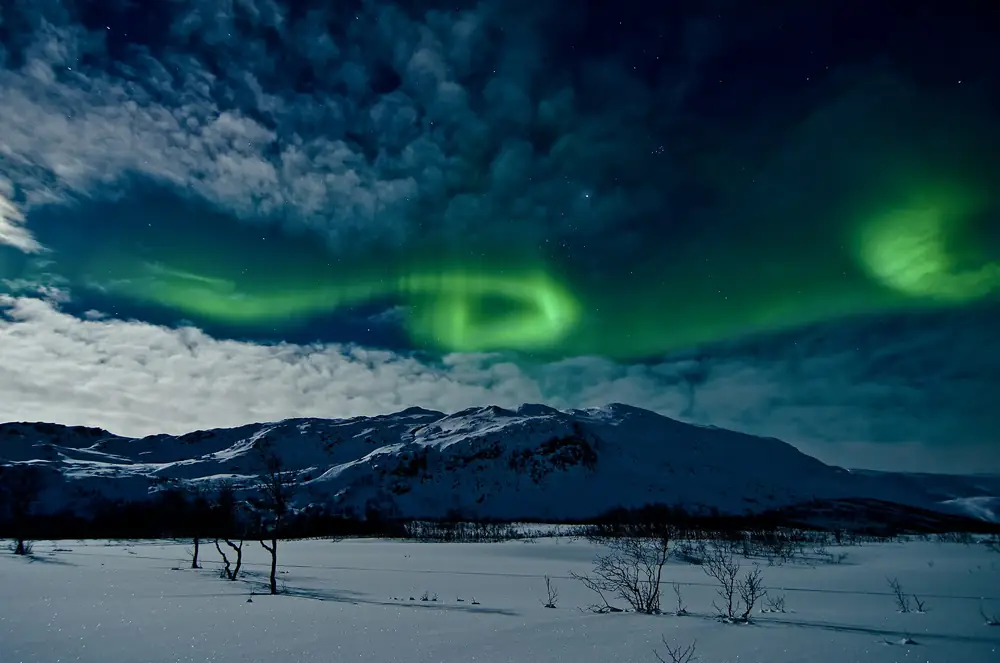 Northern lights over a snowy valley